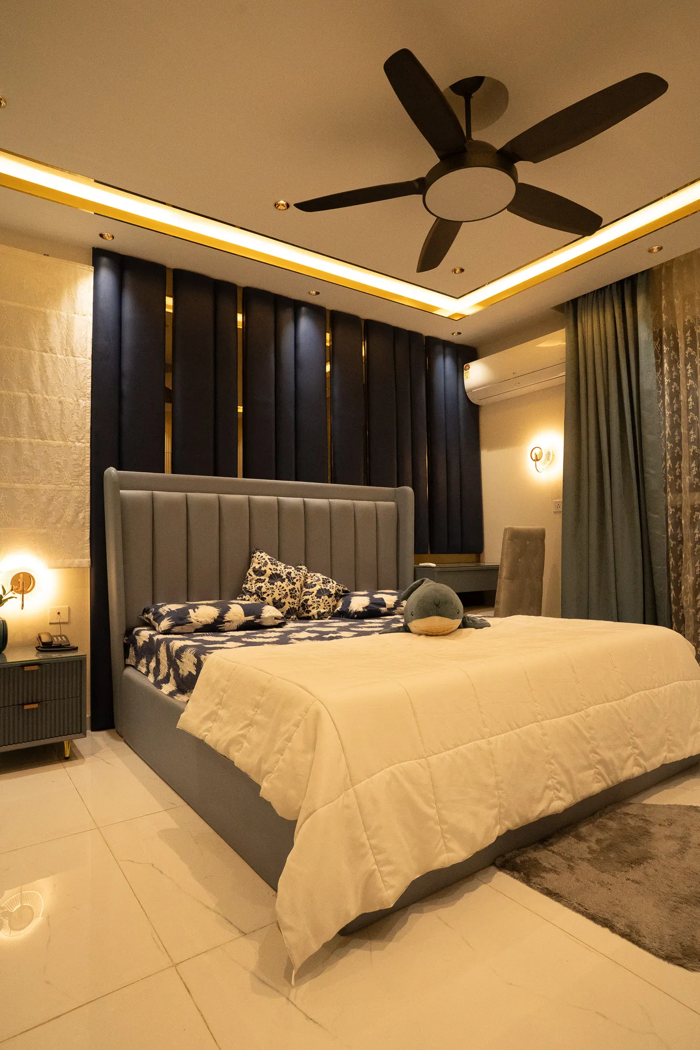 Bedroom with grey bed, dark wall panels and cove ceiling — Divyarjuna